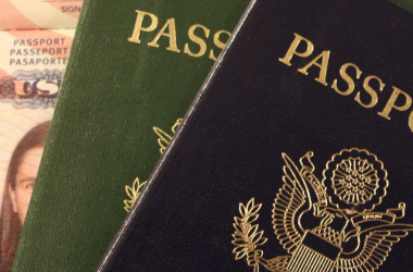 a green and blue passport on an American ID card